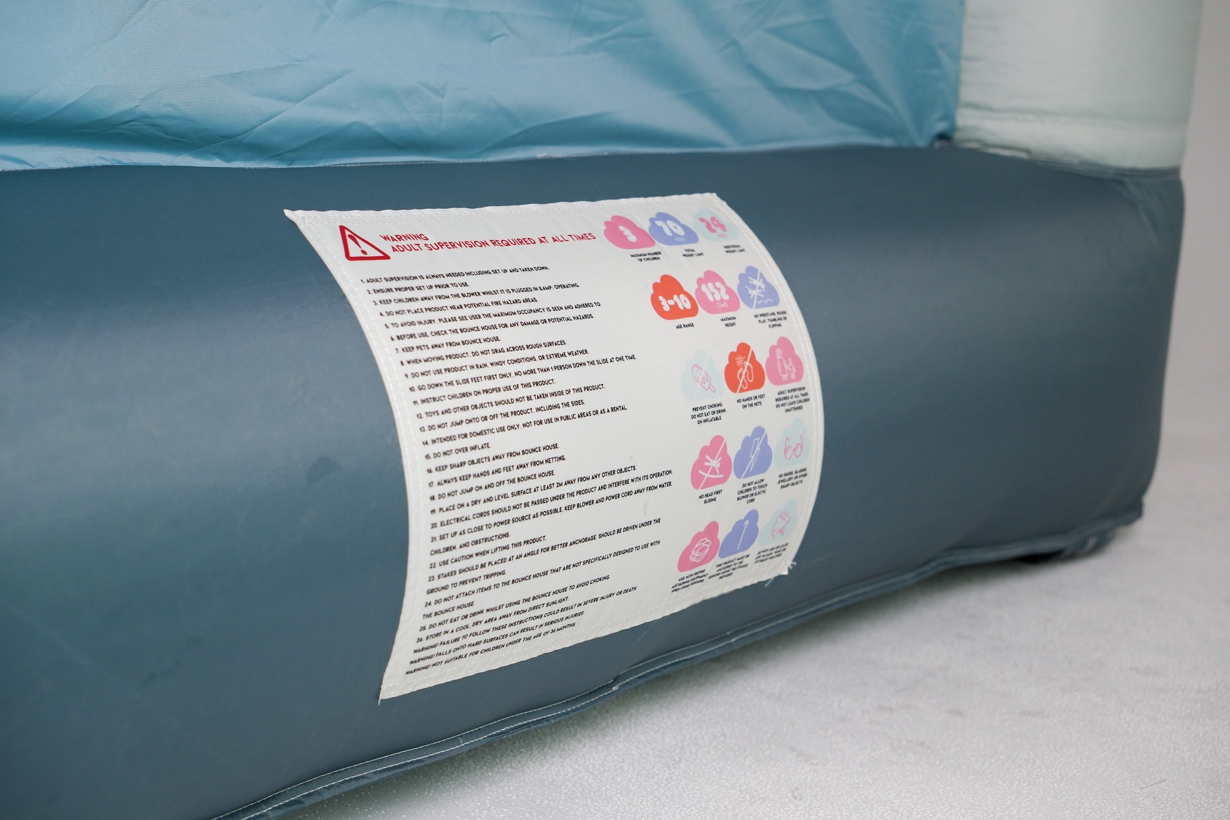 Inflating Arch-O-Rama bounce house with air pump – quick indoor setup
