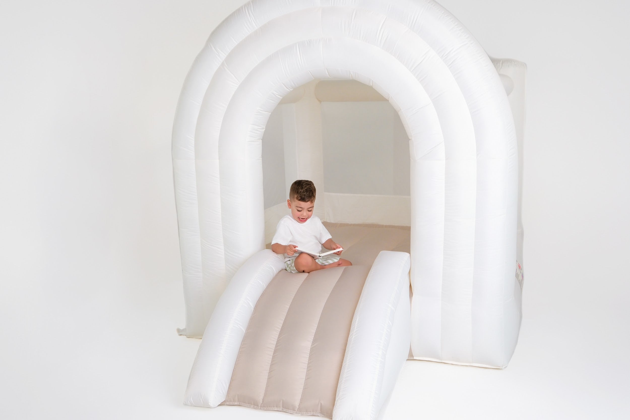 Toddler entering Arch-O-Rama bounce house – designed for safe indoor access
