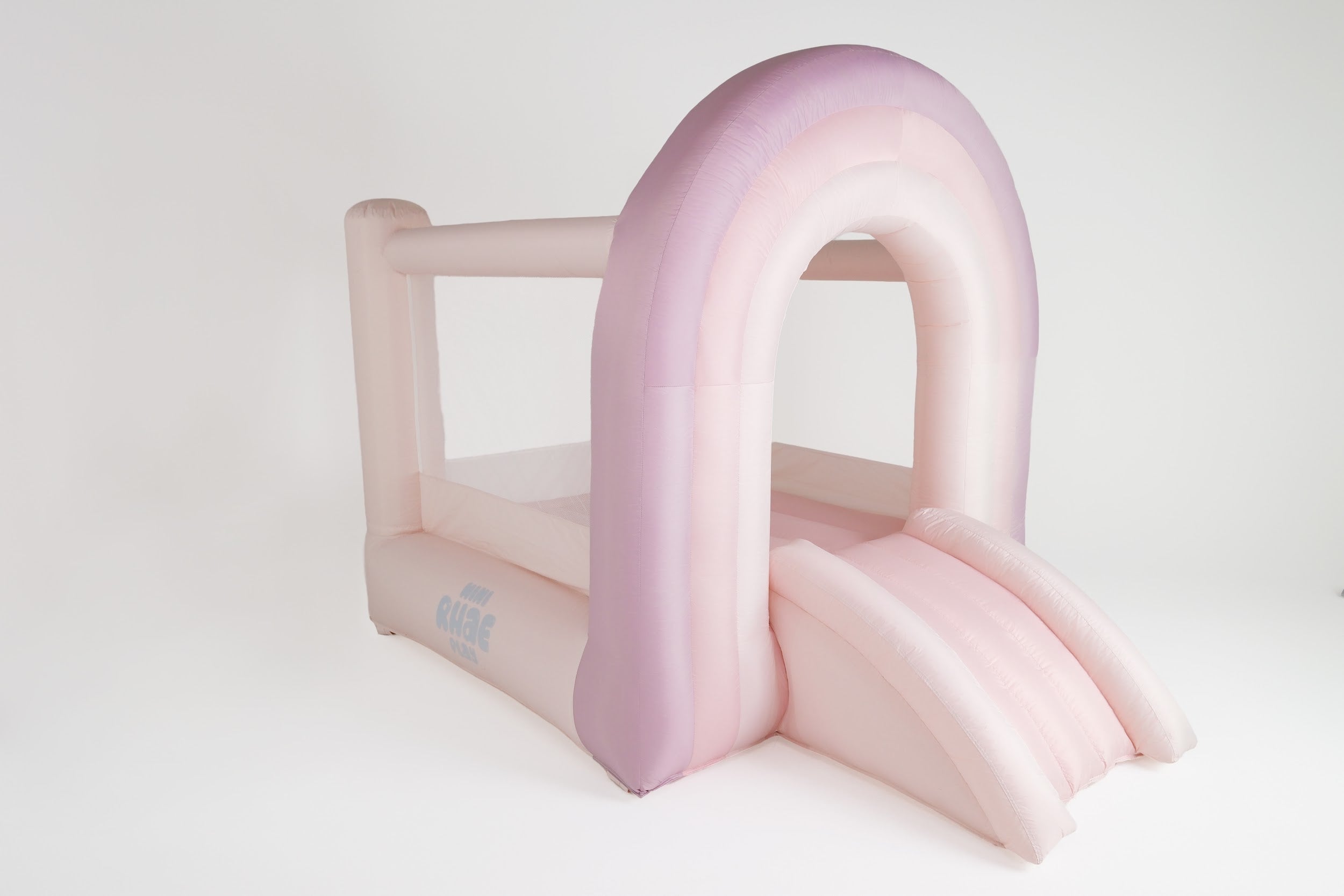 Montessori indoor climbing arch in kids' playroom. Pink inflatable arch on a white background